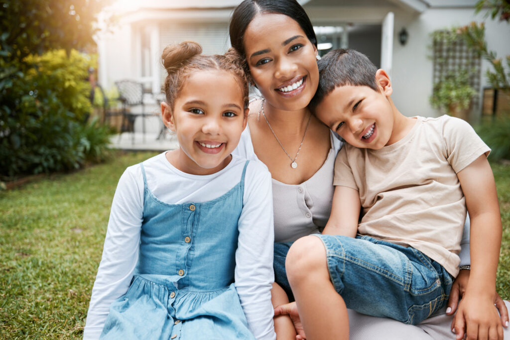 Family bonding, smiling and enjoying new house, garden and backyard as real estate investors, homeowners and buyers. Portrait of single mother, son and daughter with home insurance sitting together.